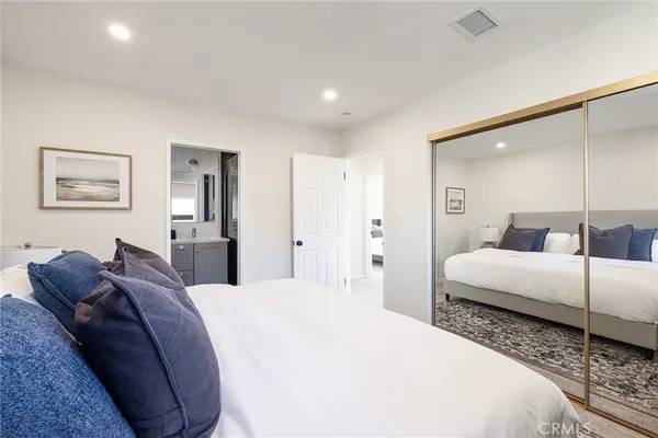 a spacious bedroom with a bed and a couch