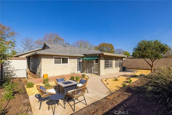 a view of a yard with furniture and a fire pit