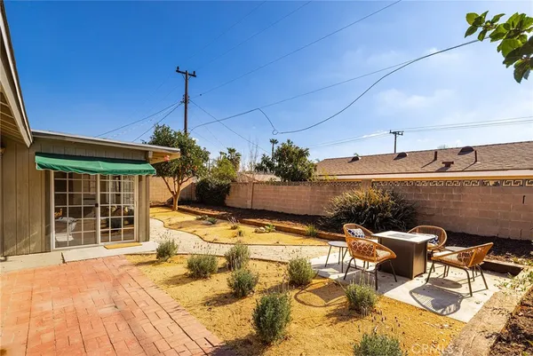 a view of a patio with a table and chairs