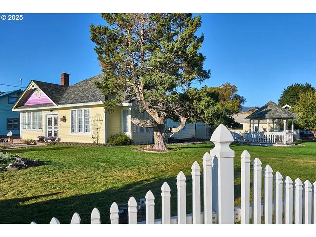 a front view of a house with a garden
