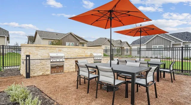 a outdoor space with patio couches and a fireplace