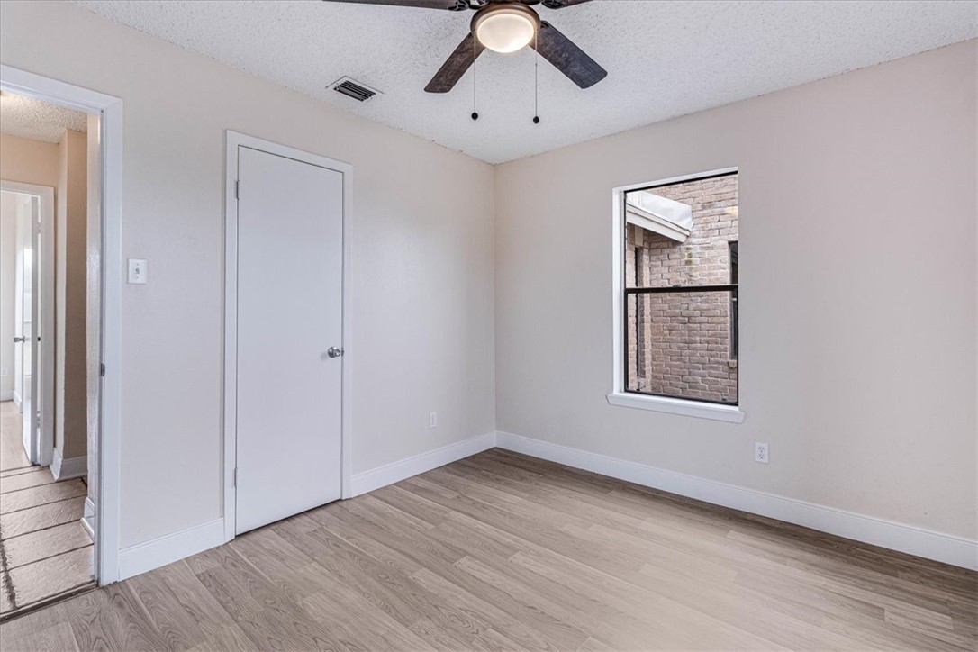 985 Crossbill Street Corpus Christi, TX 78418 - Photo 15 of 40 wooden floor in an empty room with a window