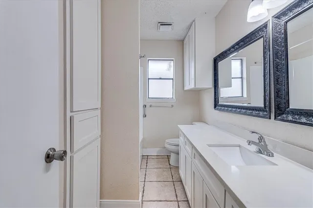 a bathroom with a sink toilet and mirror