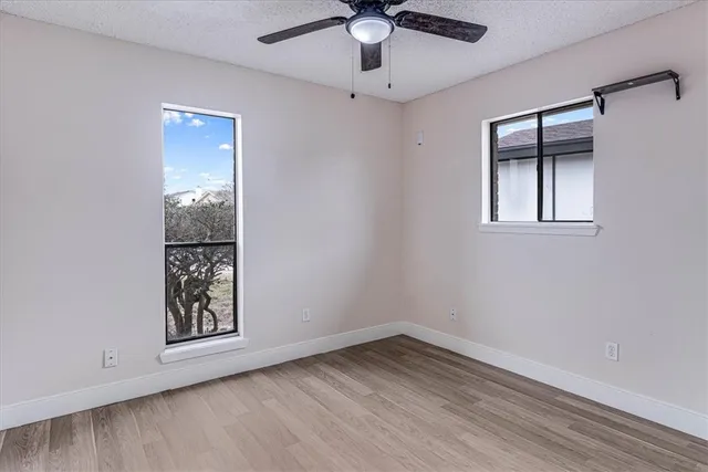 wooden floor in an empty room with a window