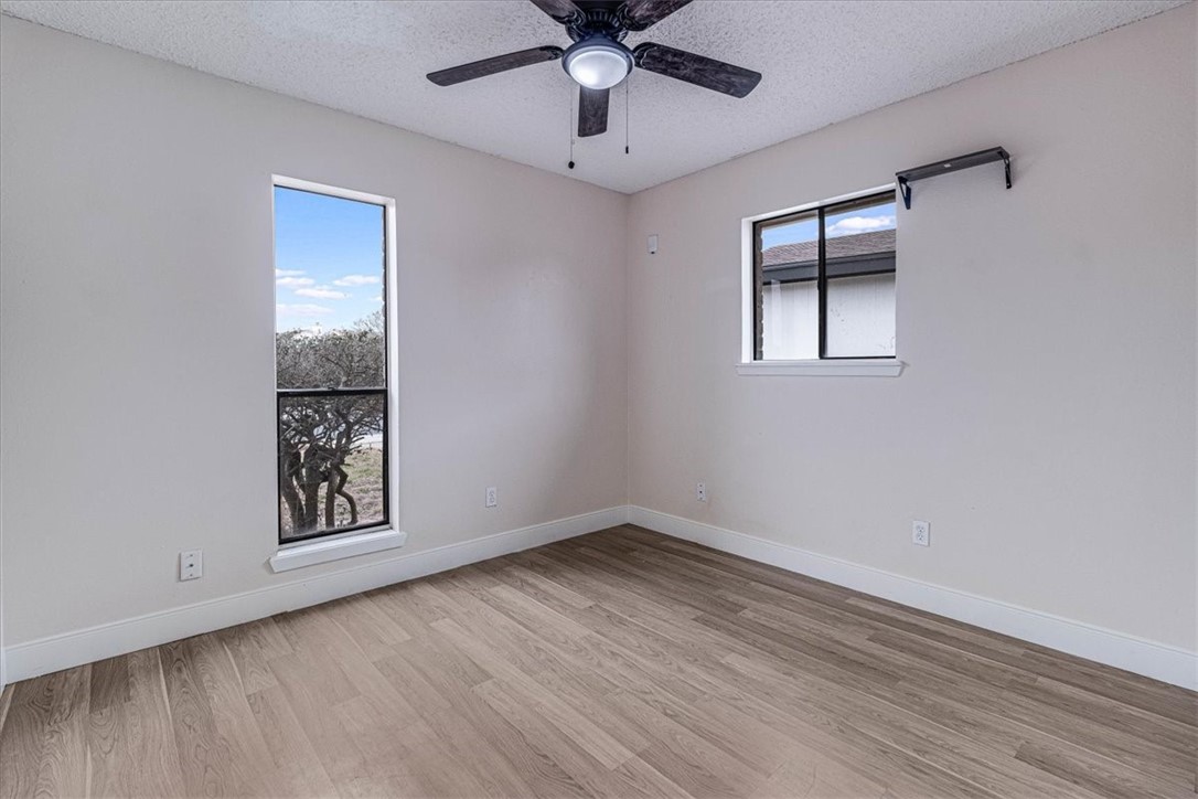 985 Crossbill Street Corpus Christi, TX 78418 - Photo 22 of 40 a view of an empty room with window and wooden floor