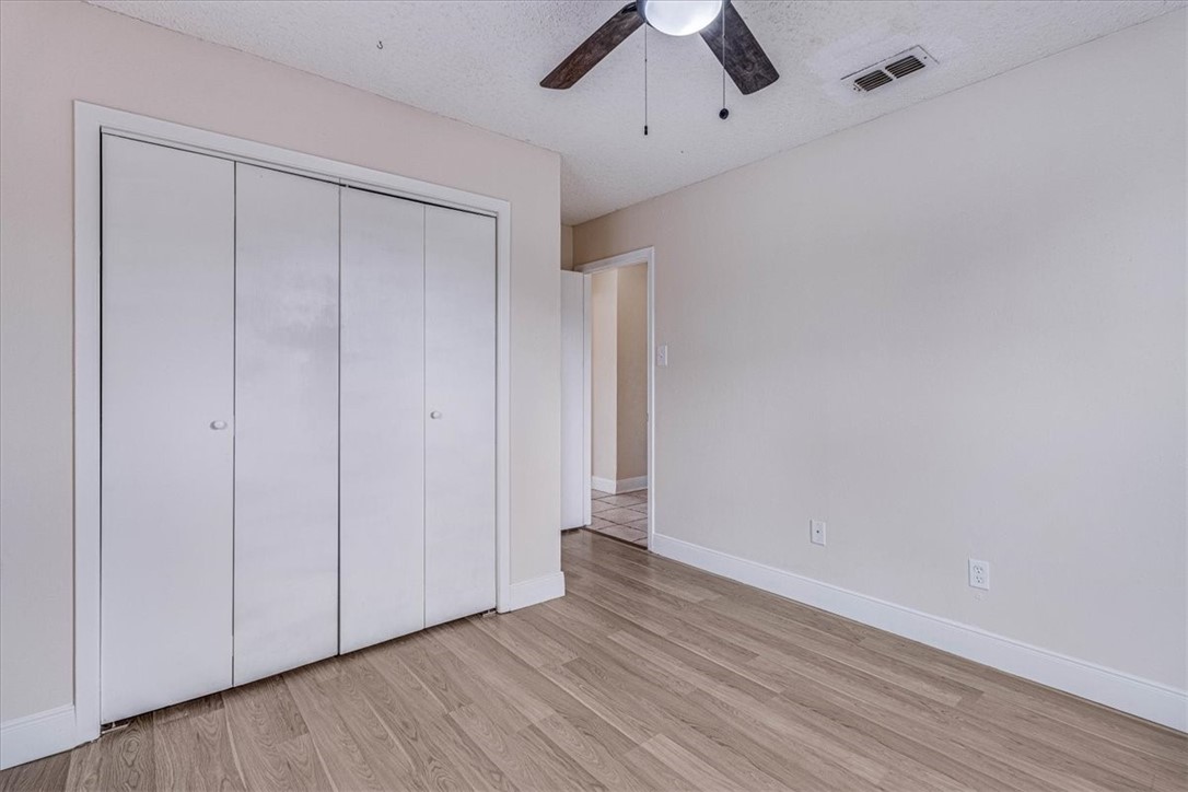 985 Crossbill Street Corpus Christi, TX 78418 - Photo 24 of 40 a view of an empty room with wooden floor