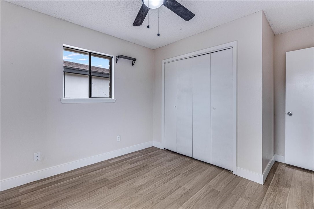 985 Crossbill Street Corpus Christi, TX 78418 - Photo 25 of 40 a view of empty room with wooden floor and fan