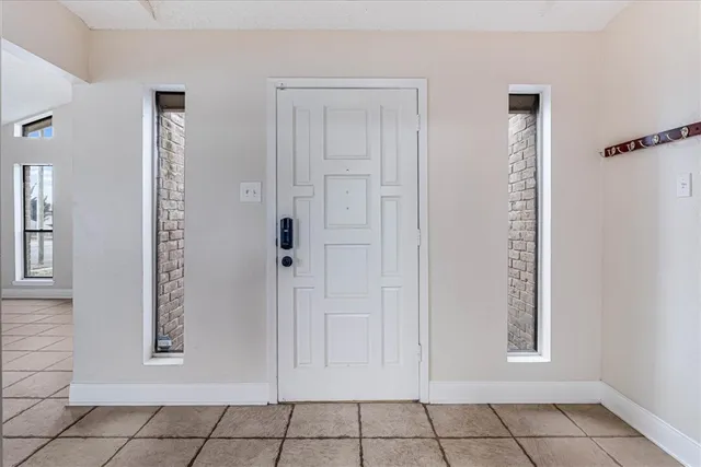 an empty room with window and bathroom
