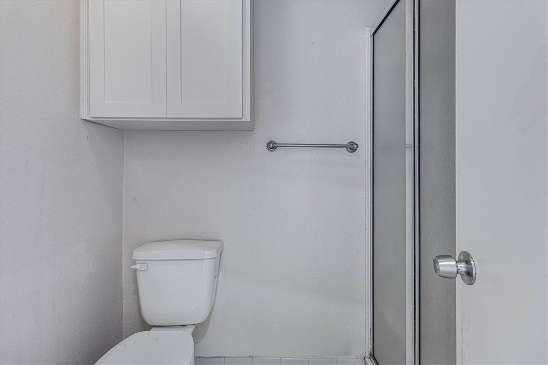 985 Crossbill Street Corpus Christi, TX 78418 - Photo 32 of 40 a white toilet sitting next to a bathroom sink