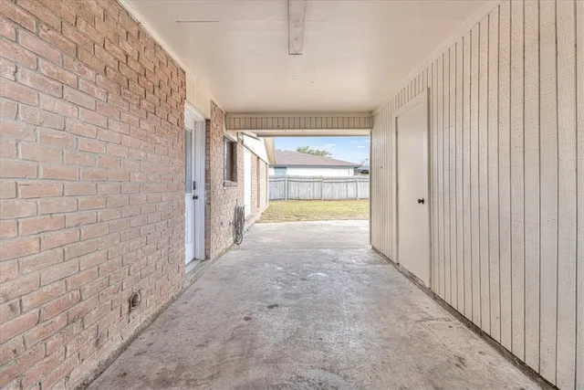a view of a hallway with wooden door