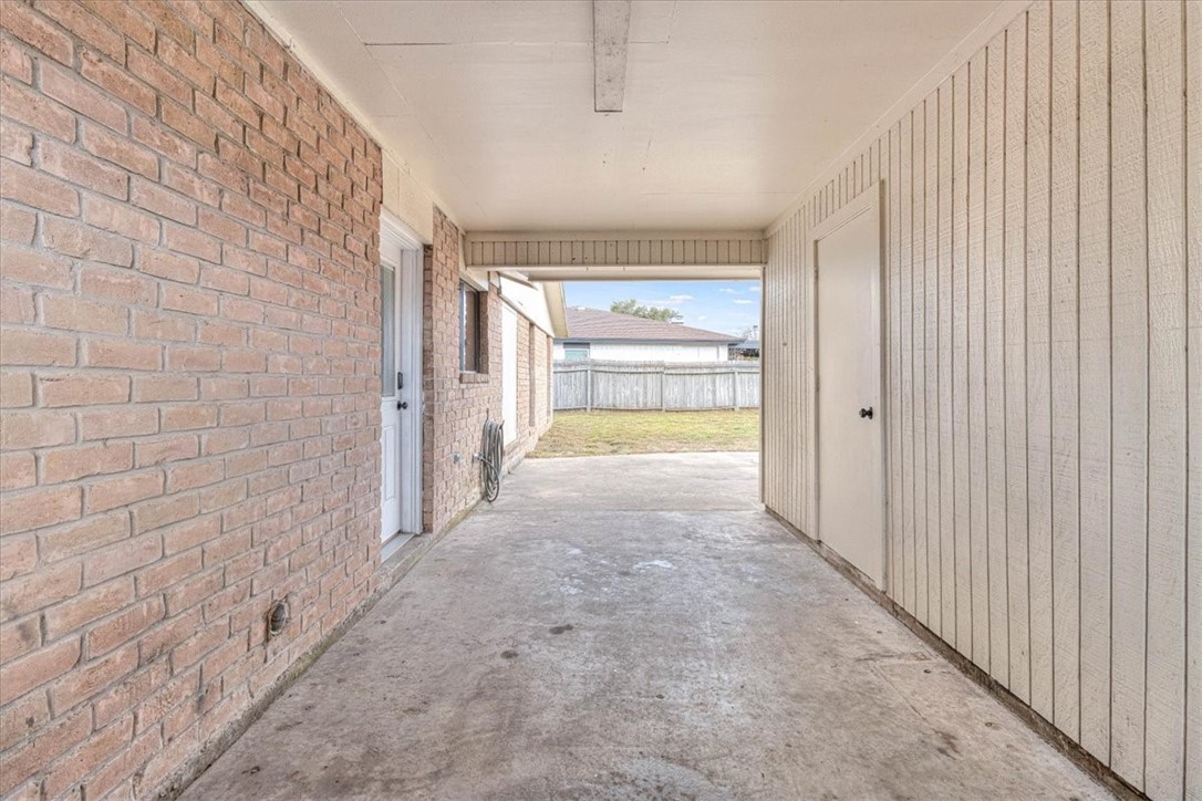 985 Crossbill Street Corpus Christi, TX 78418 - Photo 33 of 40 a view of a hallway with a wooden fence