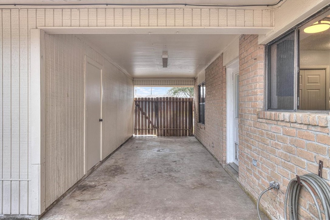 985 Crossbill Street Corpus Christi, TX 78418 - Photo 34 of 40 a view of a hallway with wooden door
