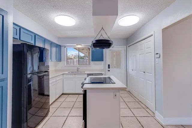 a kitchen with a sink a refrigerator and a stove