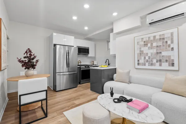 a living room with furniture and kitchen view