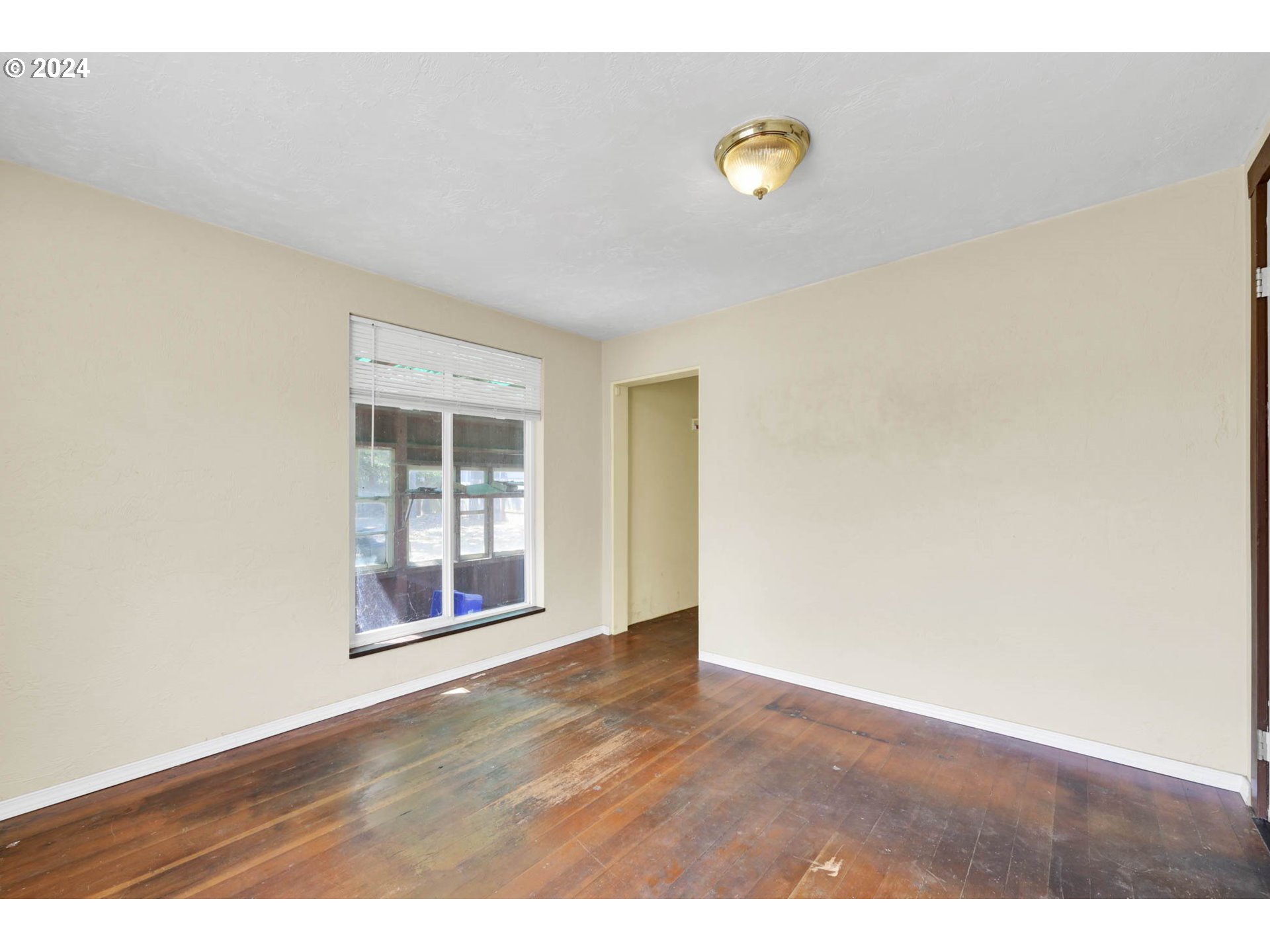 1004 North 3rd Place Springfield, OR 97477 - Photo 12 of 33 a view of an empty room with wooden floor and a window