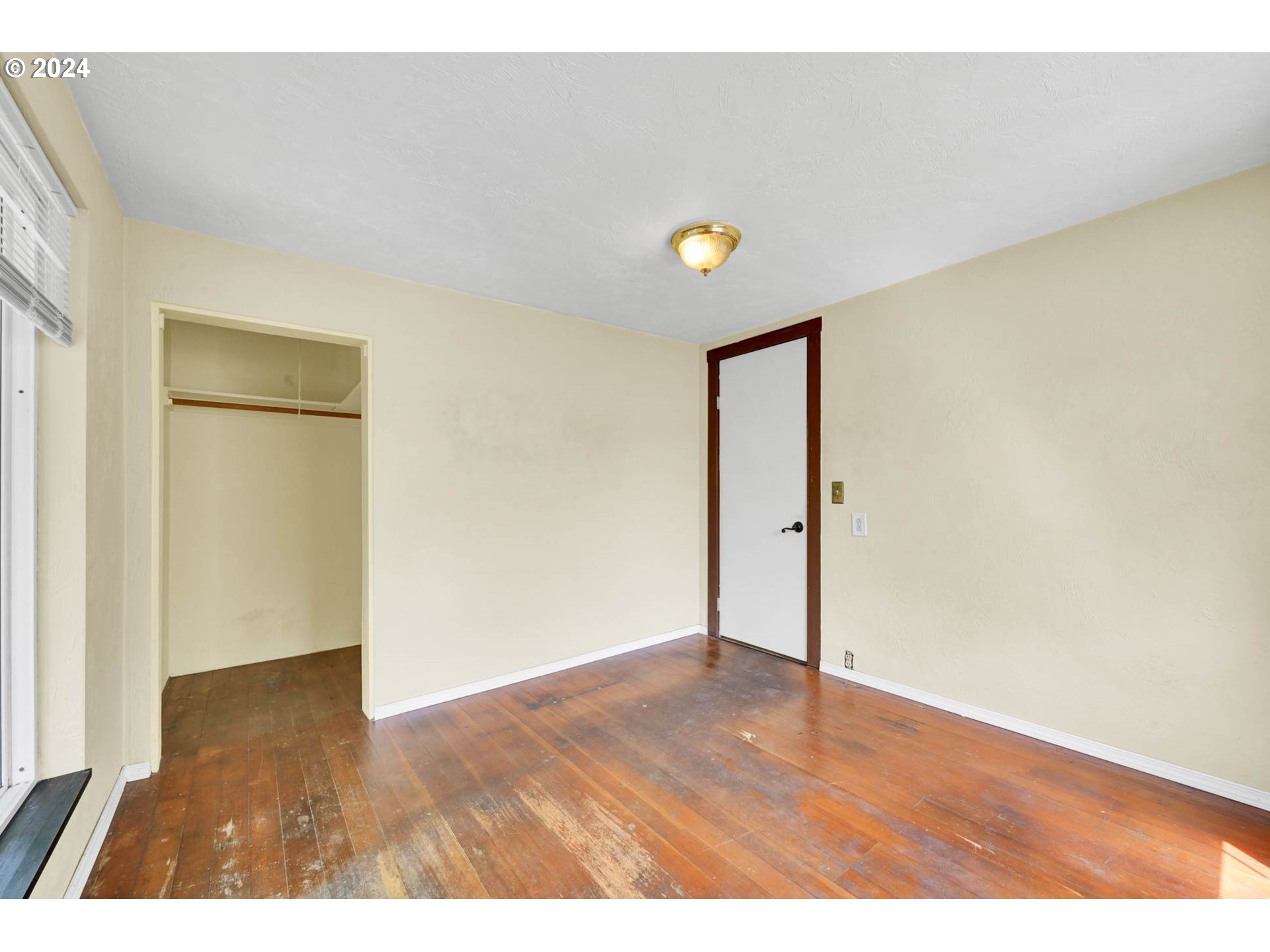 1004 North 3rd Place Springfield, OR 97477 - Photo 13 of 33 a view of an empty room with wooden floor and closet