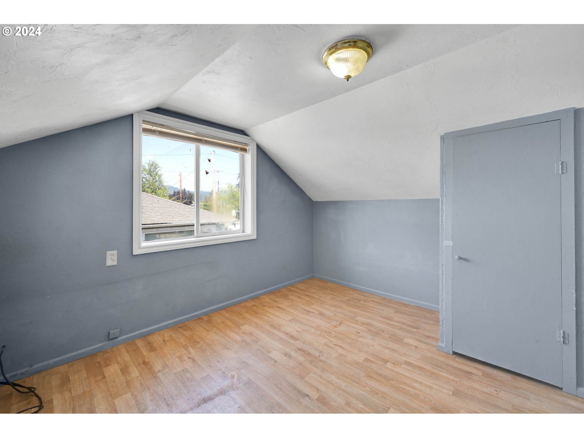1004 North 3rd Place Springfield, OR 97477 - Photo 17 of 33 a view of an empty room with window and wooden floor