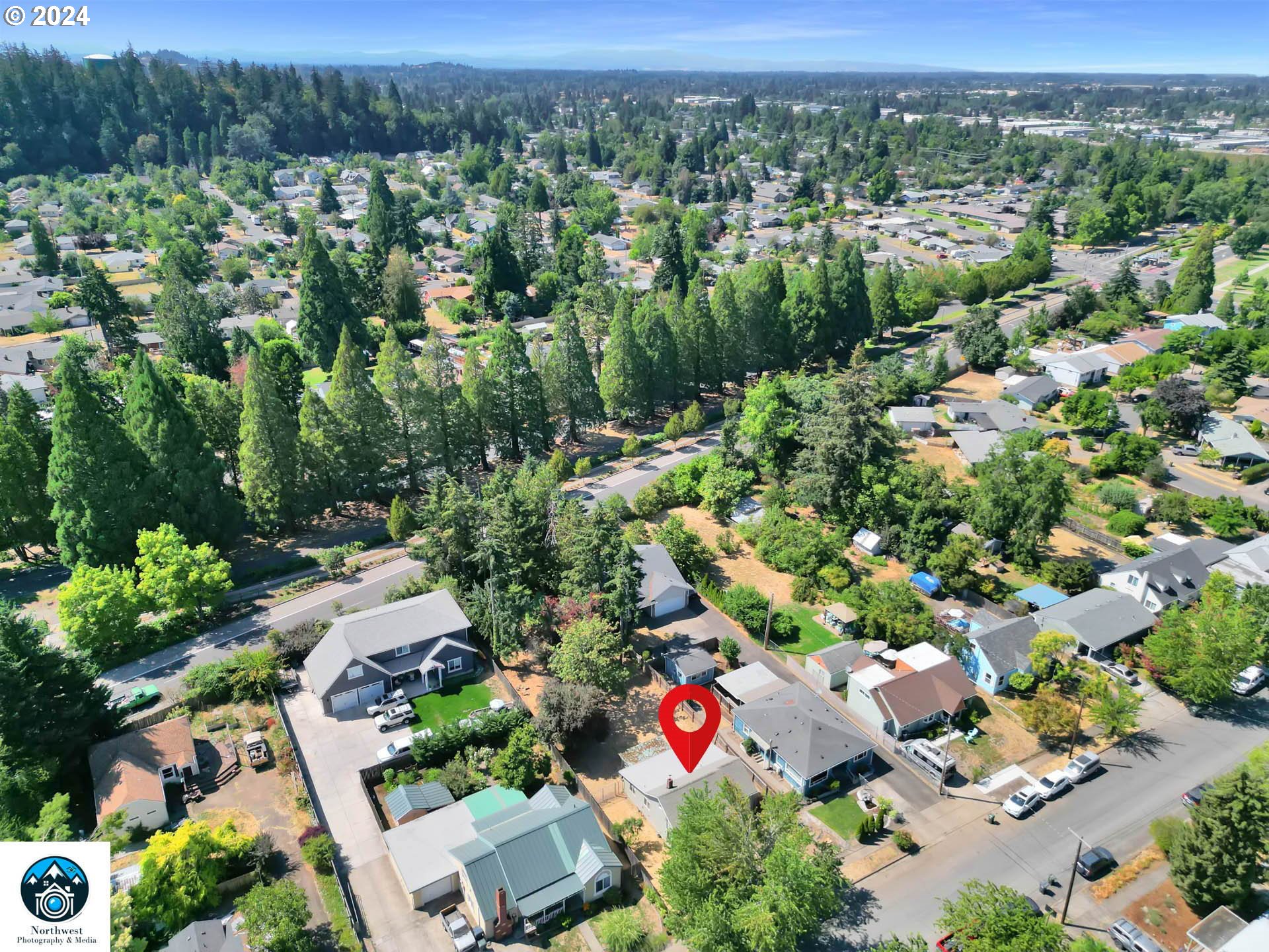 1004 North 3rd Place Springfield, OR 97477 - Photo 33 of 33 an aerial view of residential houses with outdoor space and trees