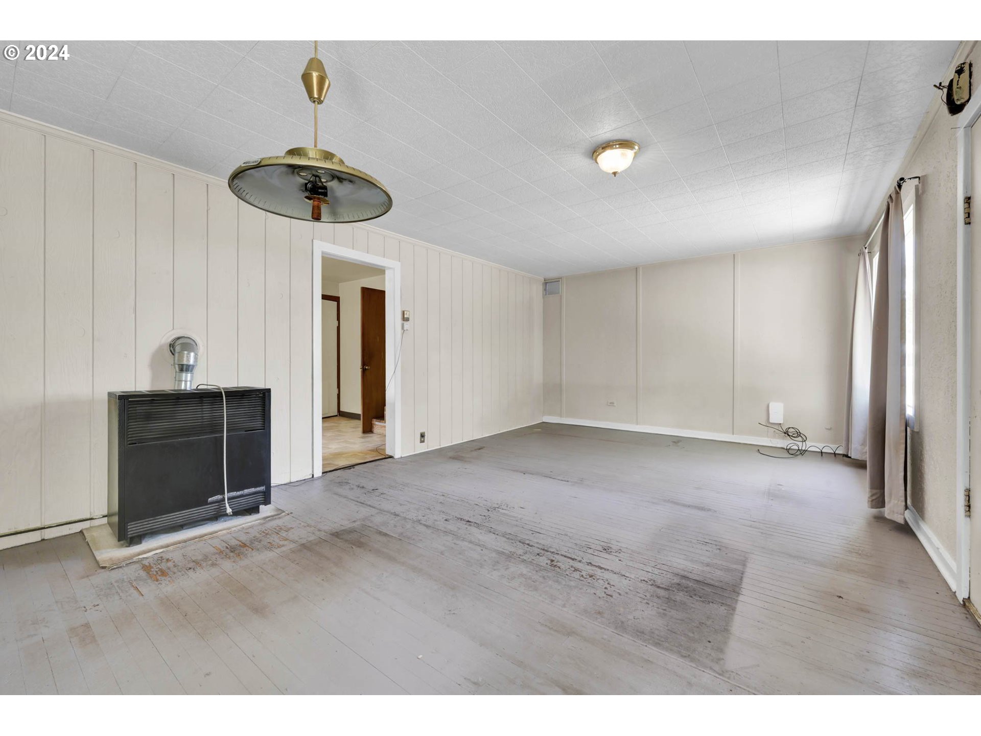 1004 North 3rd Place Springfield, OR 97477 - Photo 5 of 33 a view of an empty room with a fireplace