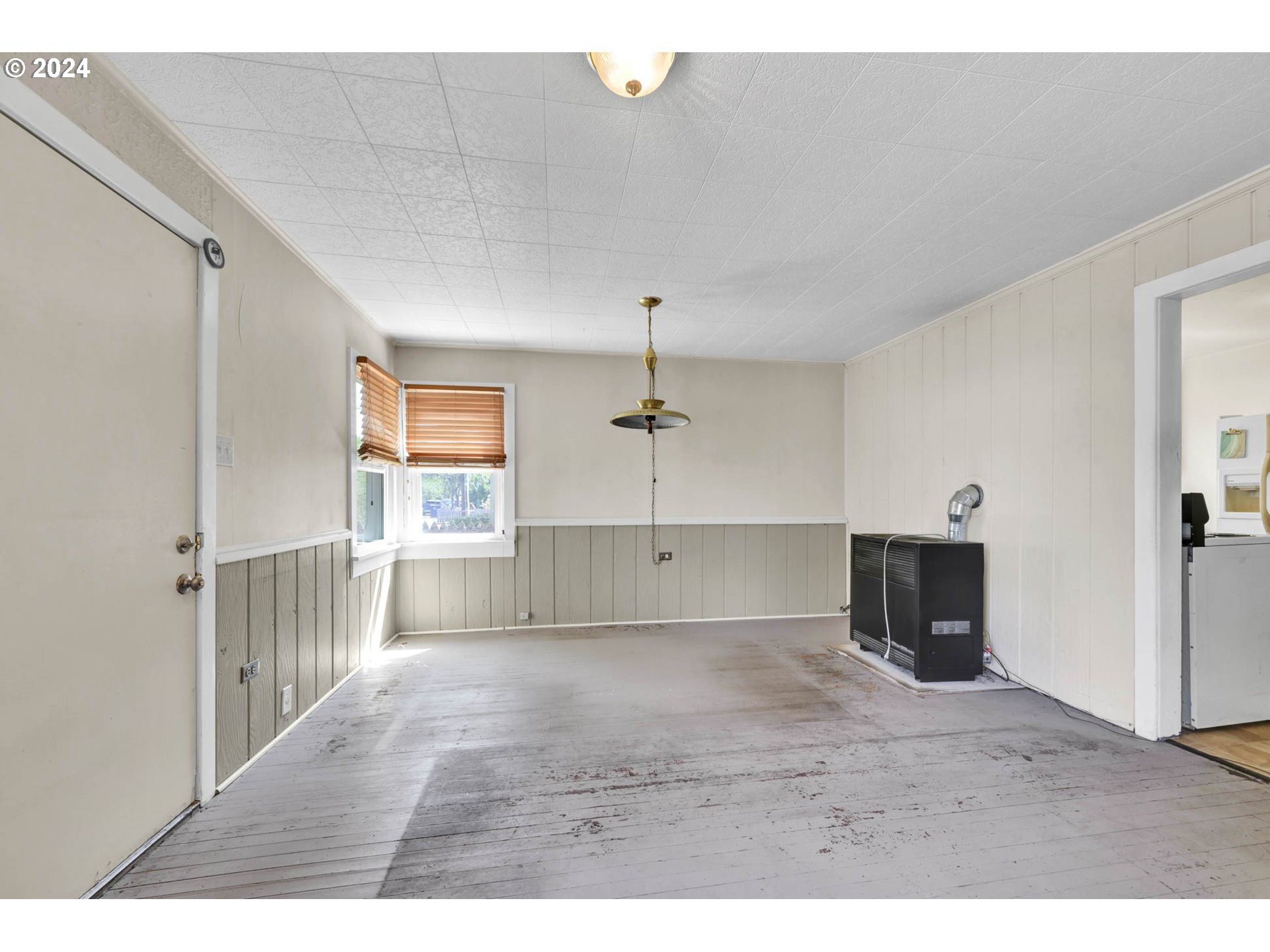 1004 North 3rd Place Springfield, OR 97477 - Photo 6 of 33 a view of a room with an empty space & wooden floor