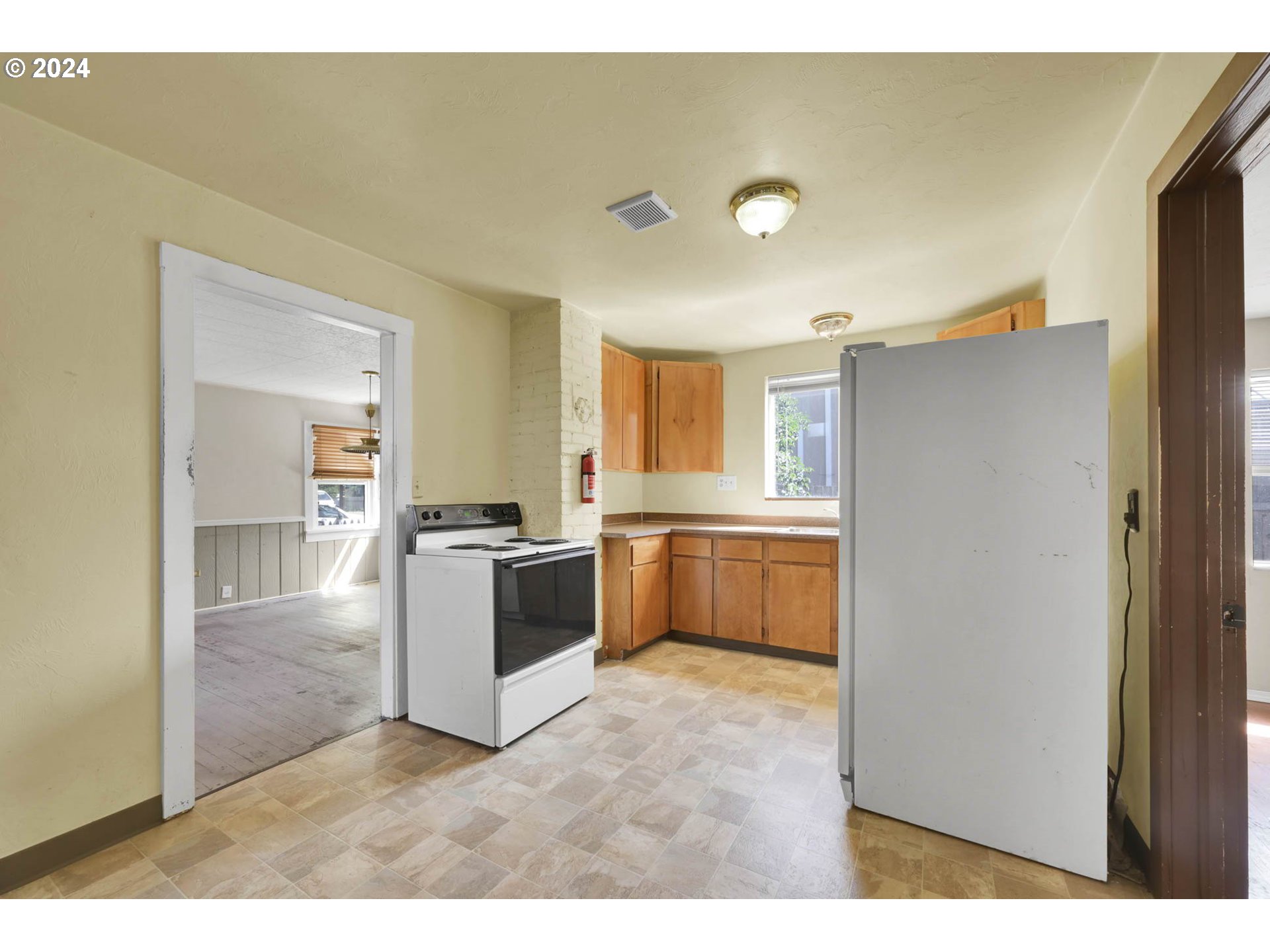 1004 North 3rd Place Springfield, OR 97477 - Photo 7 of 33 a kitchen with a refrigerator and a sink