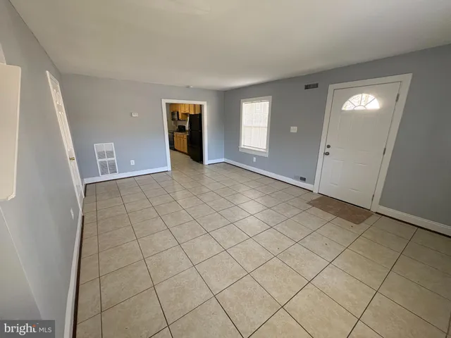 a bathroom with a tub a sink and a large mirror