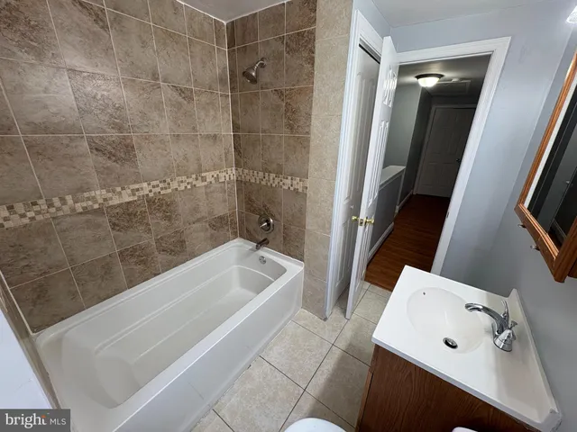 a bathroom with a tub and a window