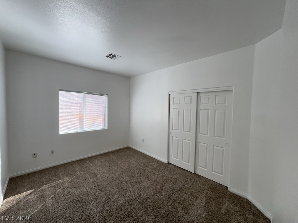 4915 East Russell Road, Unit 142 Las Vegas, NV 89120 - Photo 7 of 10 A comfortable bedroom with soft carpeting and ample closet space awaits new occupants.