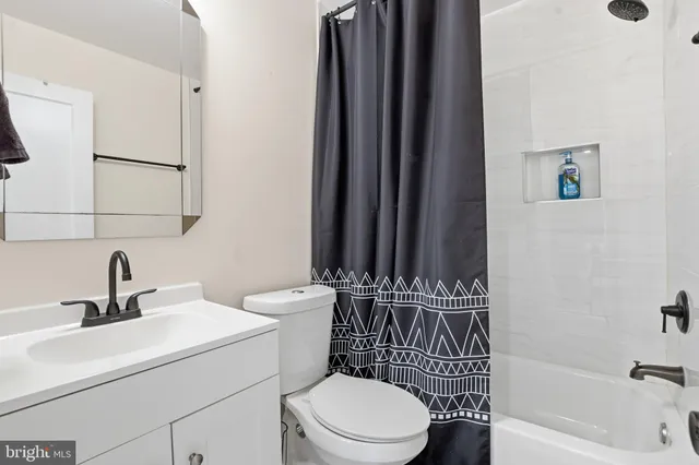 a white toilet sitting next to a bathroom sink