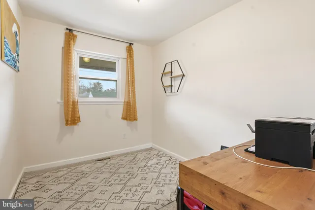 a room with a window and a ceiling fan