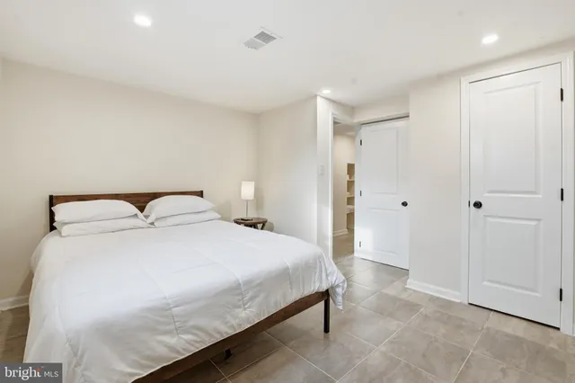 a bedroom with a bed and a table