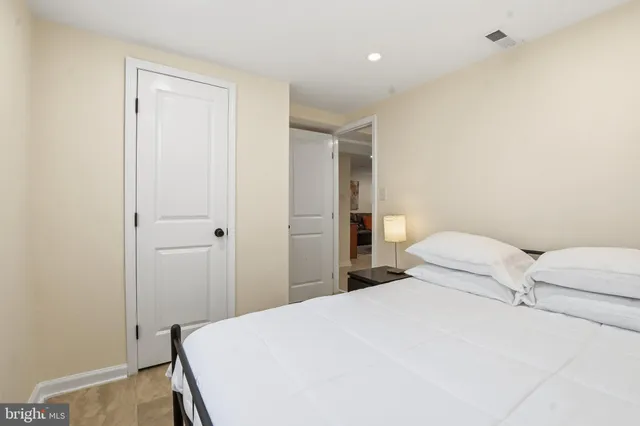 a bedroom with a bed and a table