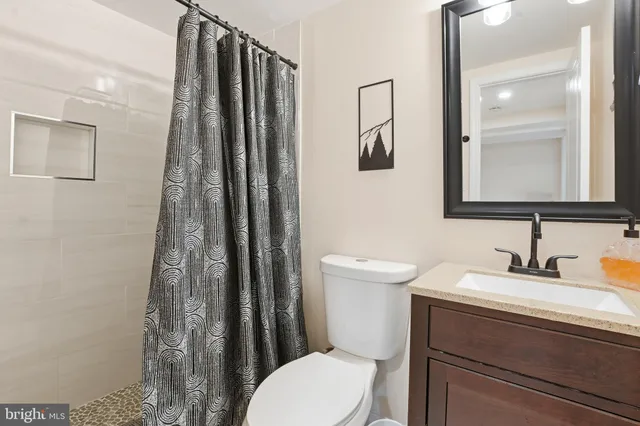 a bathroom with a toilet sink and shower