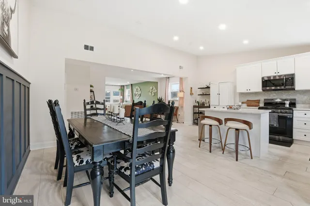 a view of a dining room with furniture and a kitchen