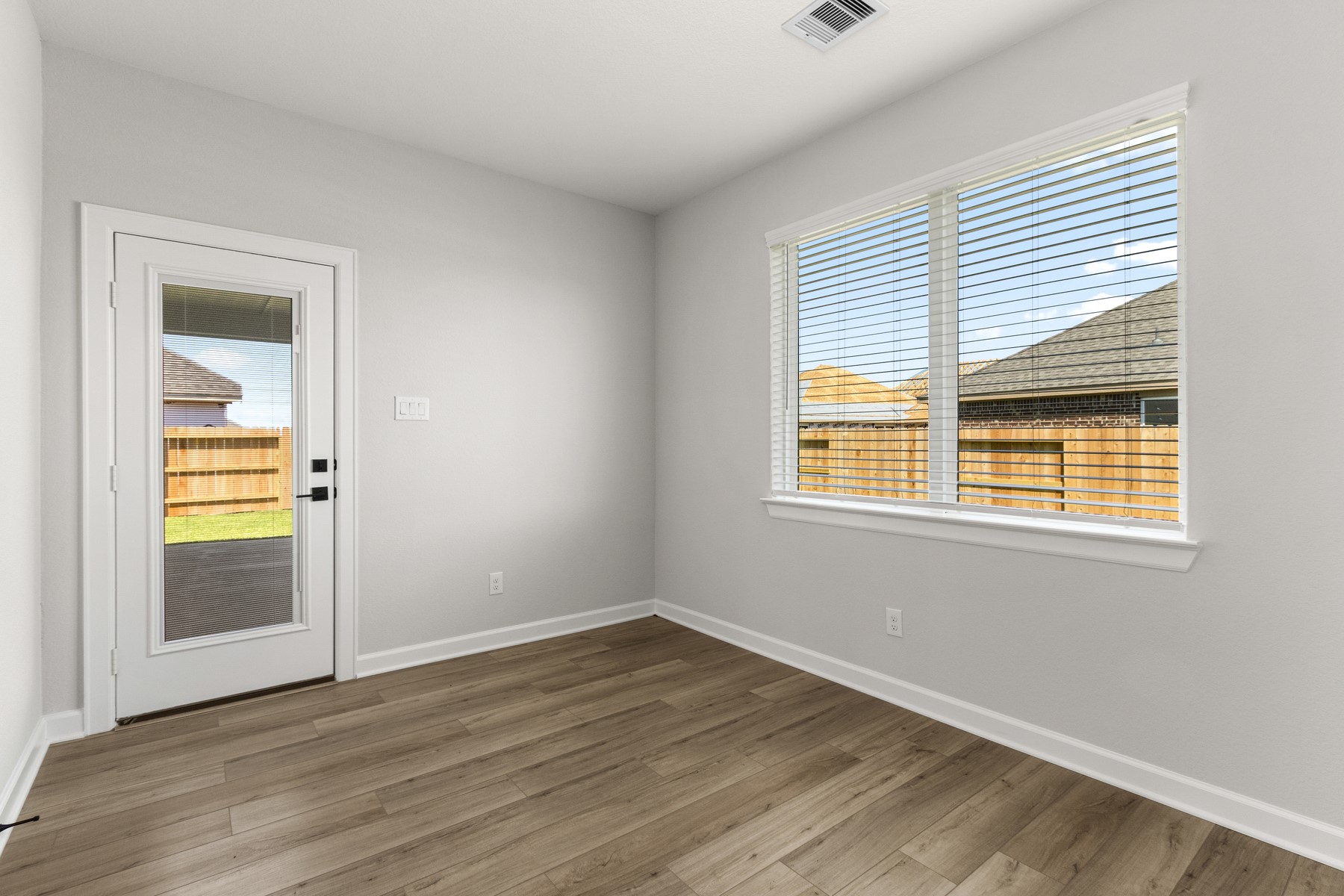 3202 Bolt Rope Drive Texas City, TX 77510 - Photo 7 of 18 a view of an empty room with wooden floor and a window