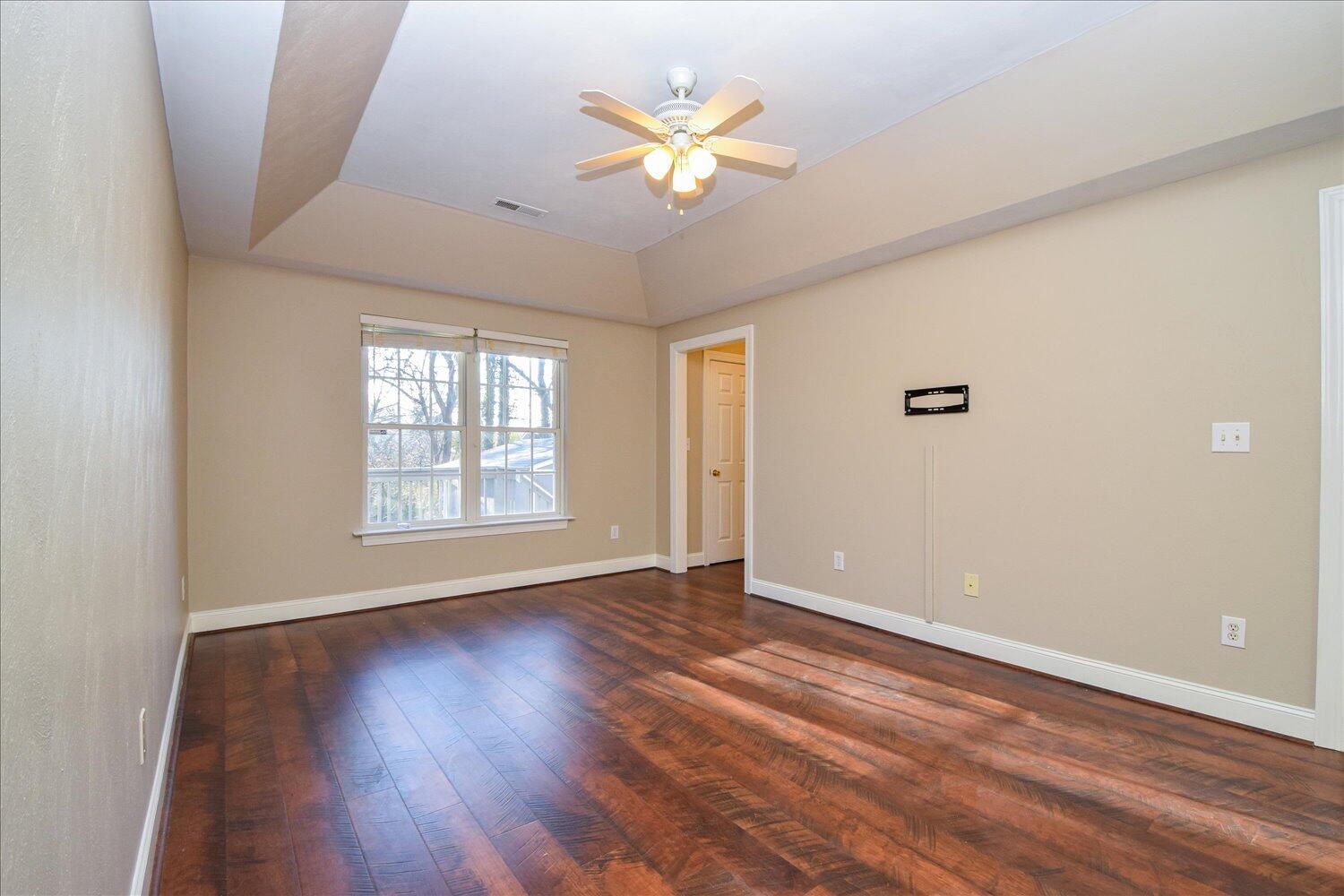 2271 Countryside Road Northwest Roanoke, VA 24017 - Photo 11 of 27 a view of an empty room with wooden floor and a ceiling fan
