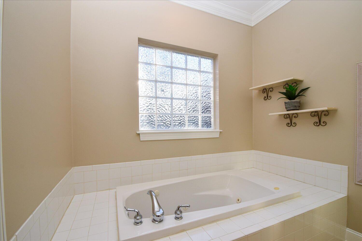 2271 Countryside Road Northwest Roanoke, VA 24017 - Photo 13 of 27 a white bath tub sitting next to a window
