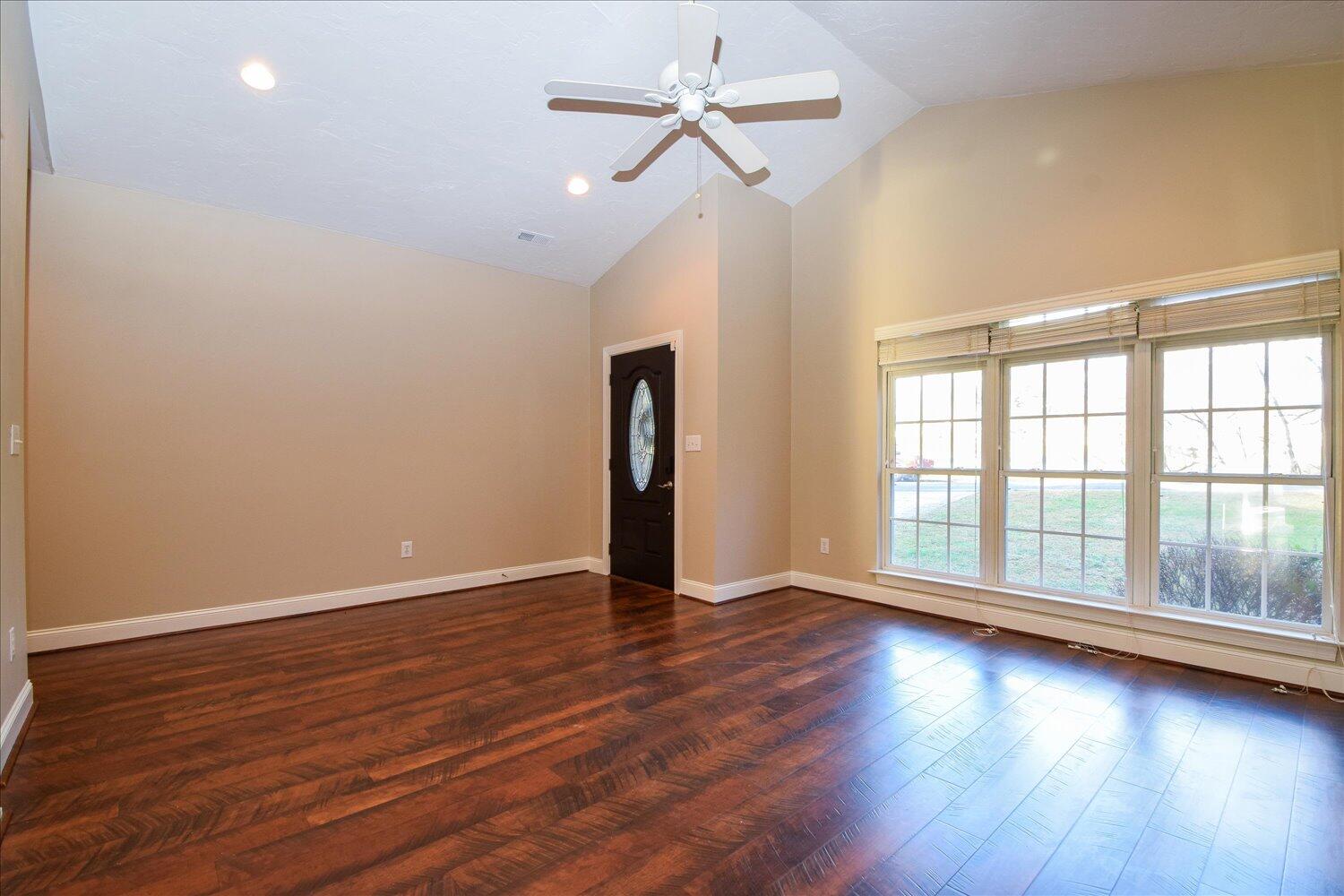 2271 Countryside Road Northwest Roanoke, VA 24017 - Photo 2 of 27 a view of an empty room with wooden floor and a window