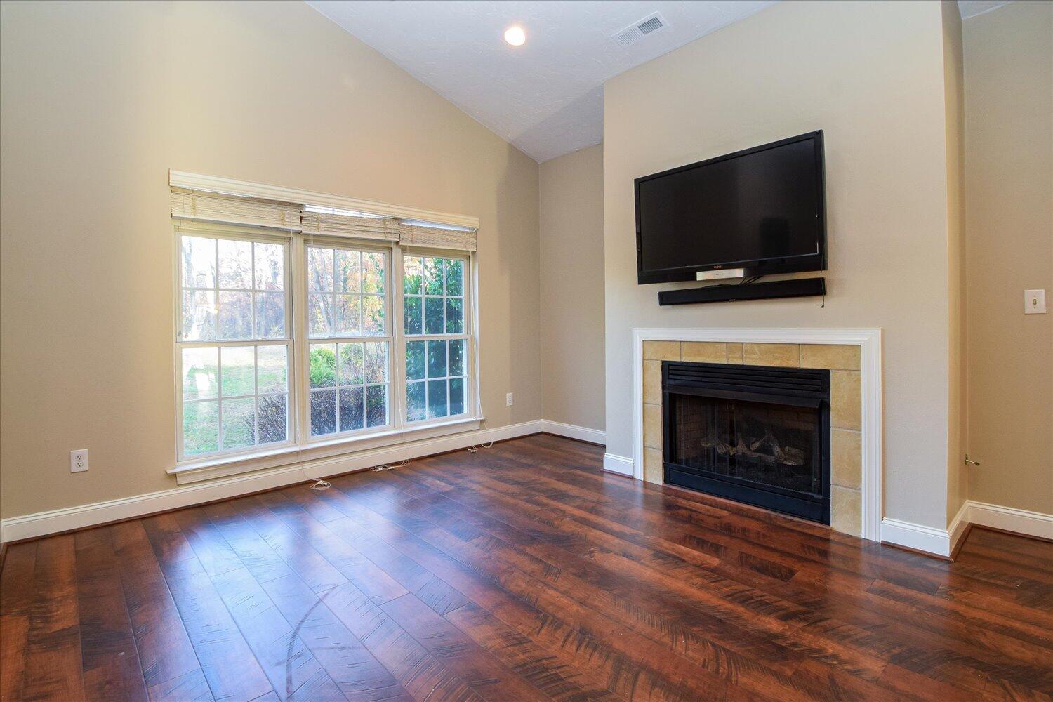 2271 Countryside Road Northwest Roanoke, VA 24017 - Photo 3 of 27 a view of empty room with wooden floor and fireplace