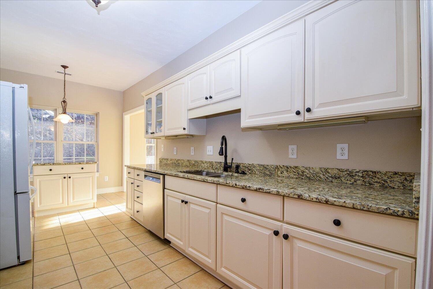 2271 Countryside Road Northwest Roanoke, VA 24017 - Photo 7 of 27 a kitchen with granite countertop white cabinets and stainless steel appliances