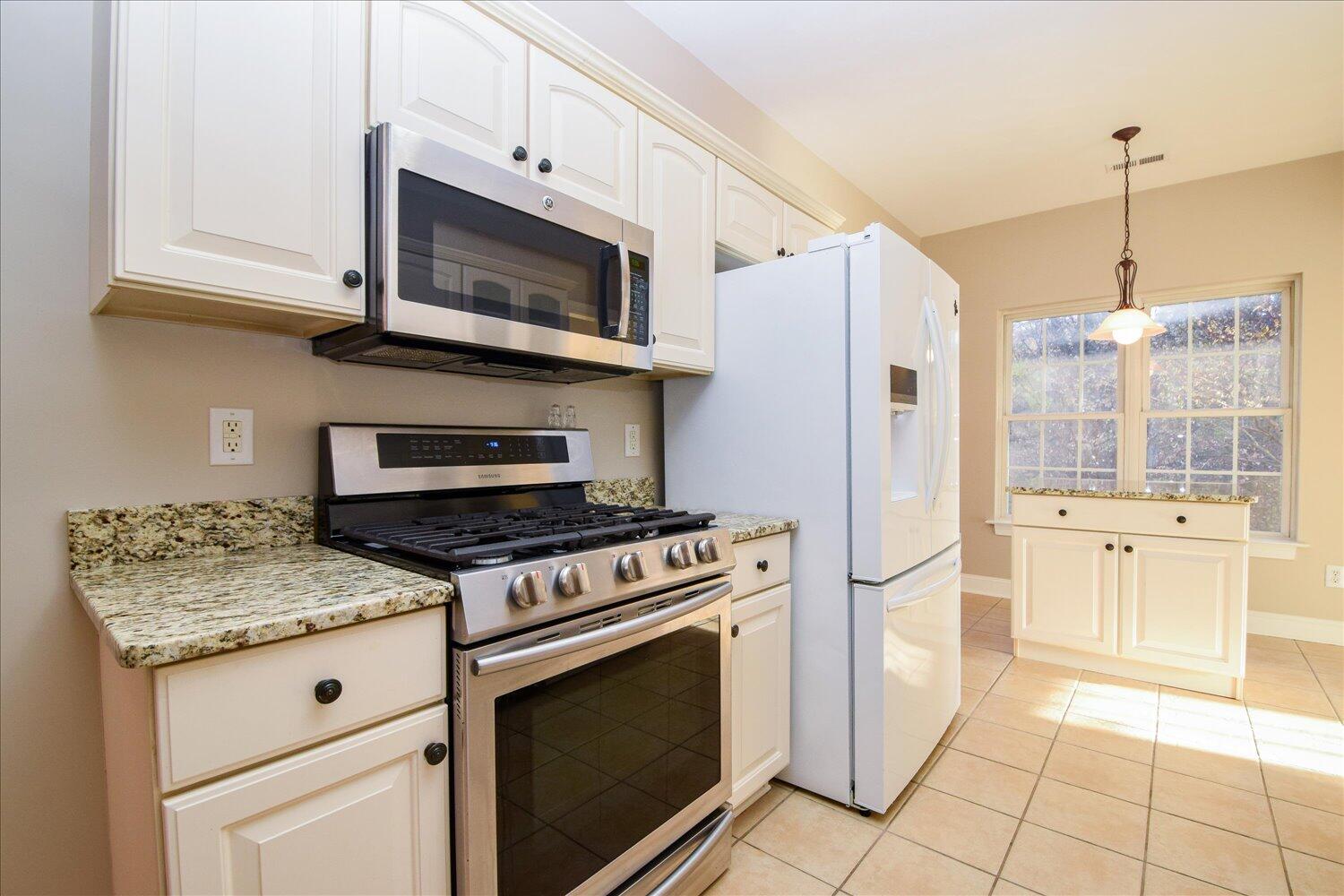 2271 Countryside Road Northwest Roanoke, VA 24017 - Photo 8 of 27 a kitchen with stainless steel appliances granite countertop a stove a refrigerator and a microwave