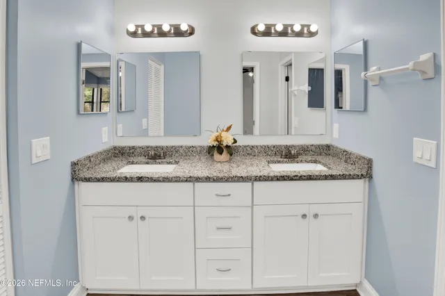 a backyard of a house with a floor to ceiling window and wooden fence
