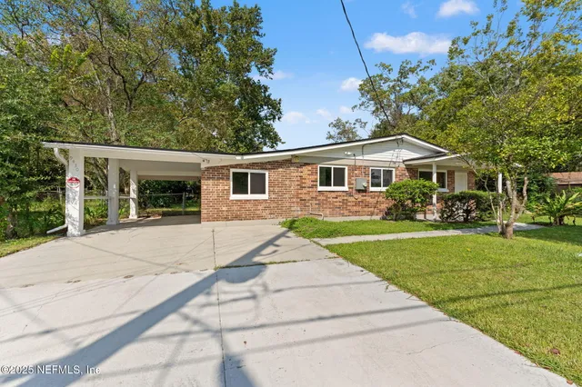 a view of house with outdoor space and garden
