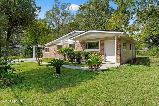 a front view of house with yard and green space