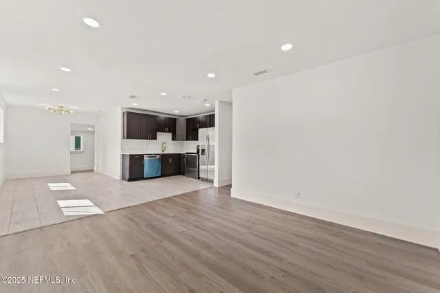 a view of kitchen with granite countertop cabinets and wooden floor