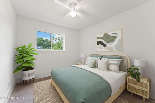 a bedroom with a bed and a potted plant