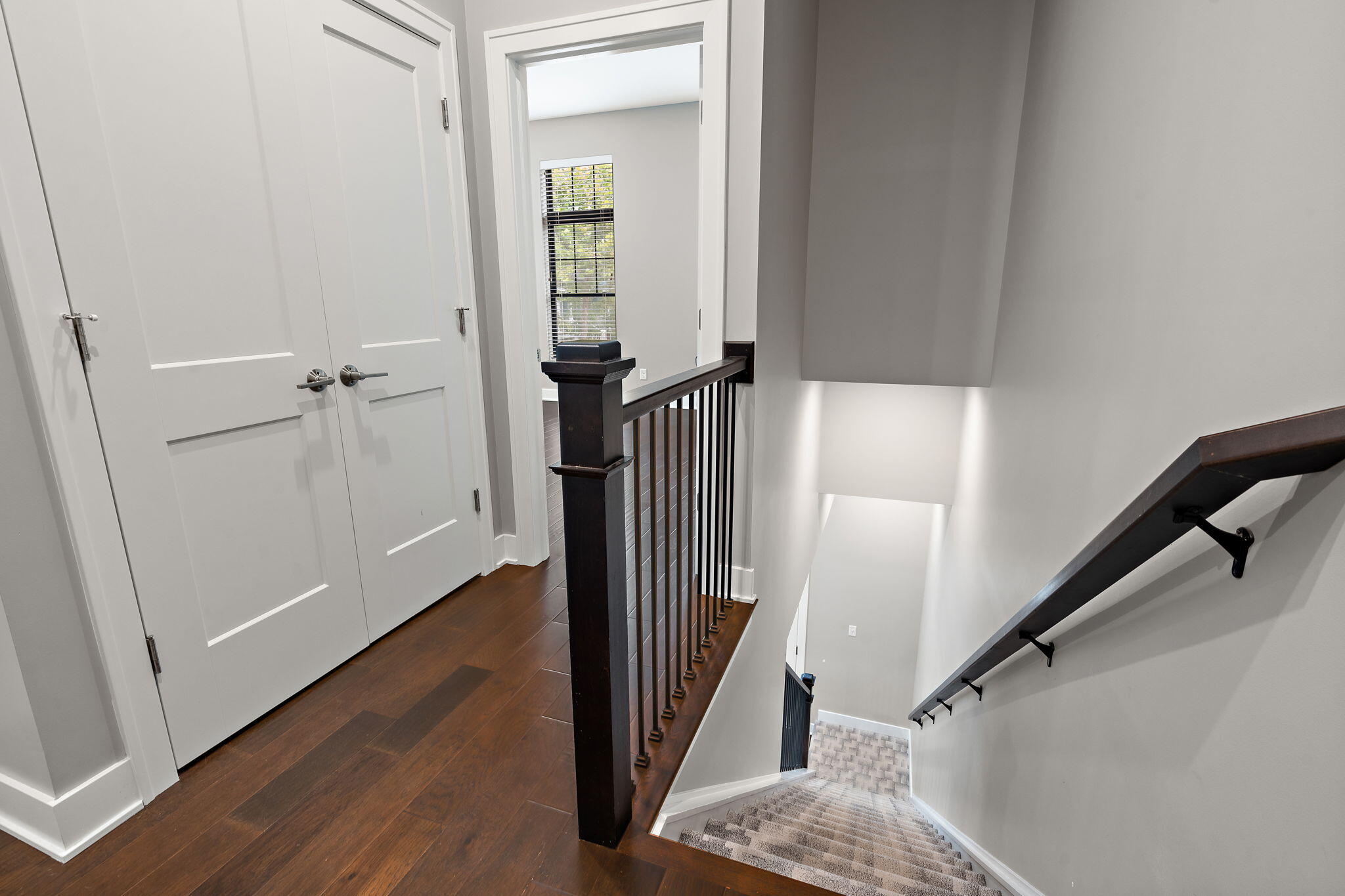 207 Academy Street, Unit 106 Valparaiso, IN 46385 - Photo 15 of 43 a view of a hallway with wooden floor and staircase