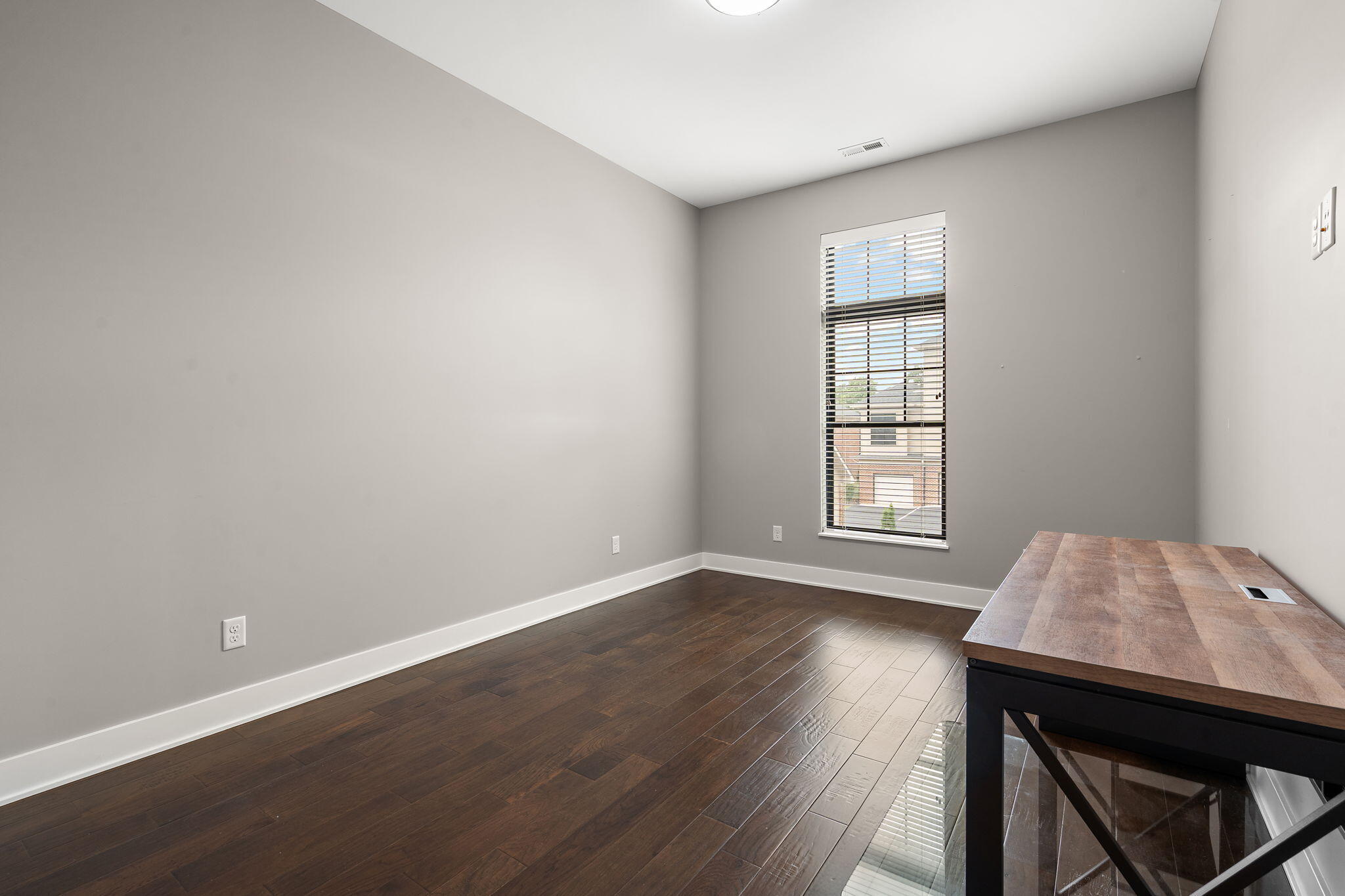207 Academy Street, Unit 106 Valparaiso, IN 46385 - Photo 27 of 43 an empty room with wooden floor and windows