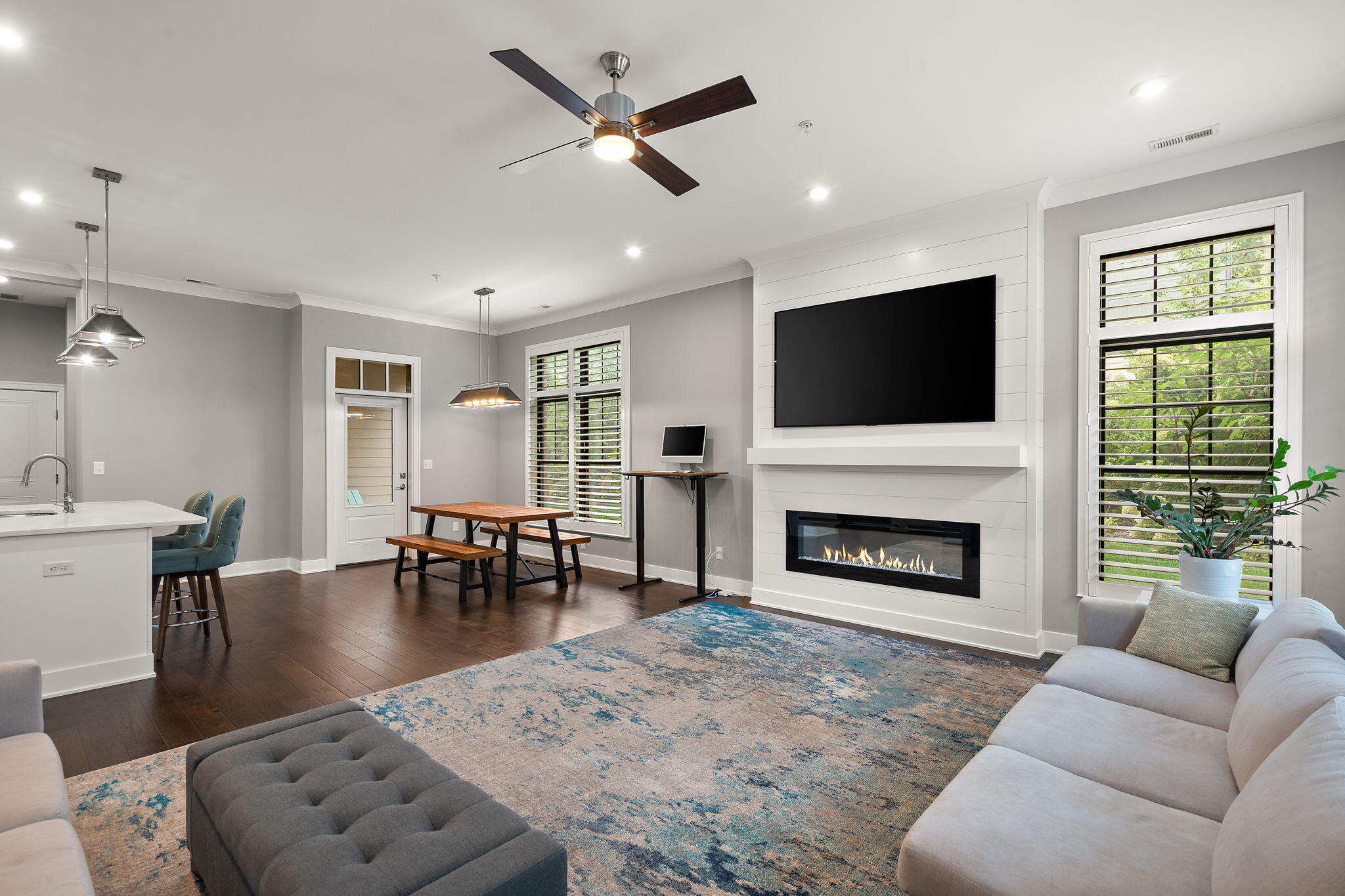 207 Academy Street, Unit 106 Valparaiso, IN 46385 - Photo 4 of 43 a living room with furniture a fireplace a flat screen tv and a large window