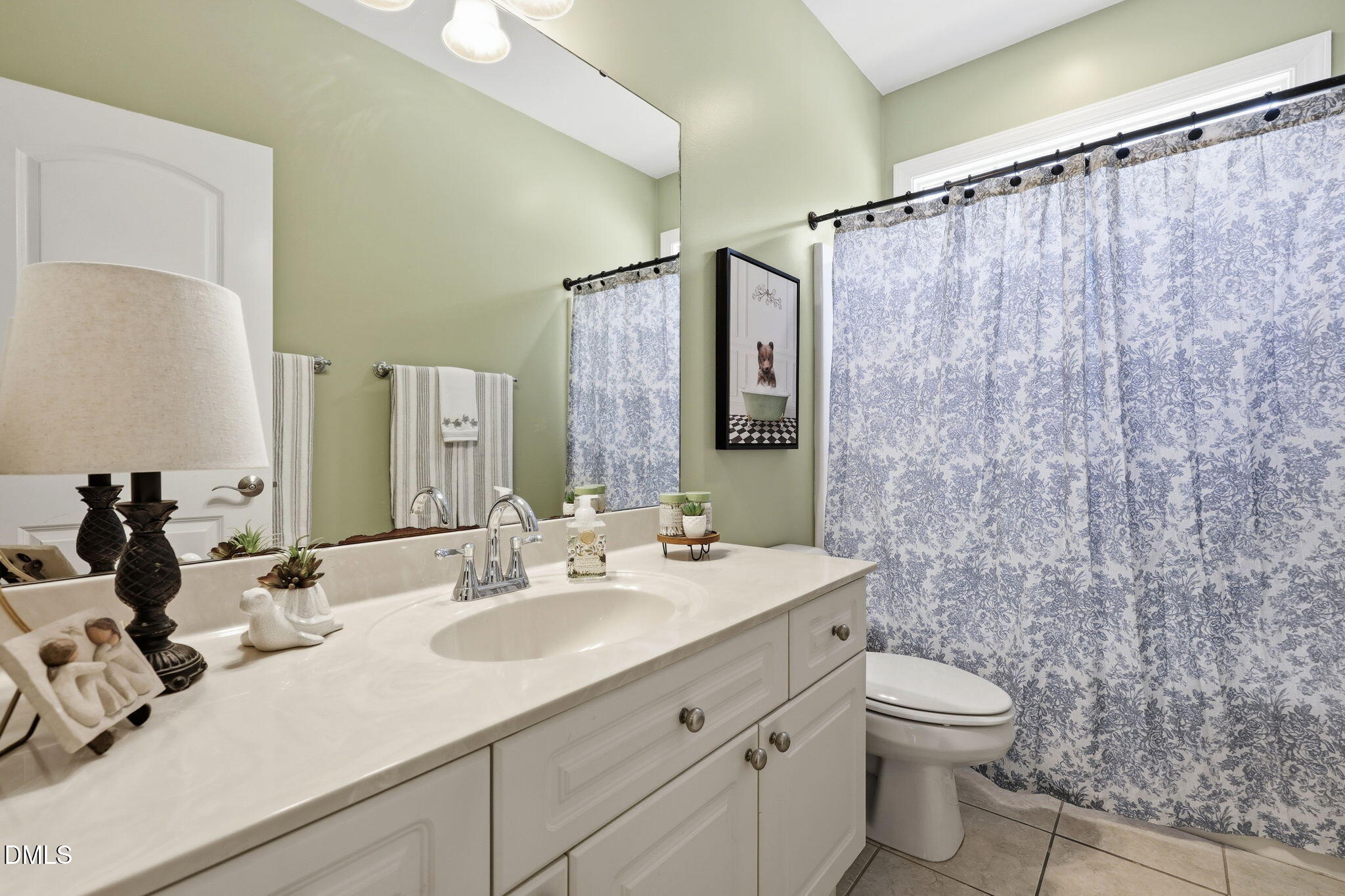 7040 Dayton Ridge Drive Apex, NC 27539 - Photo 15 of 38 a bathroom with a sink mirror vanity and toilet